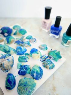 seashells and nail polish sitting on top of a table