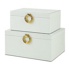 two white storage boxes with gold handles