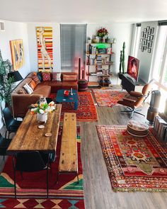 a living room filled with lots of furniture and rugs