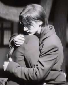 black and white photograph of a woman hugging another woman