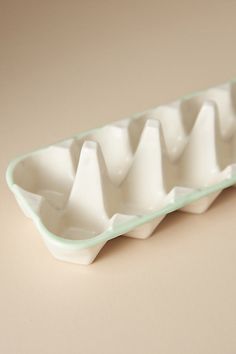 an egg tray with three eggs in it