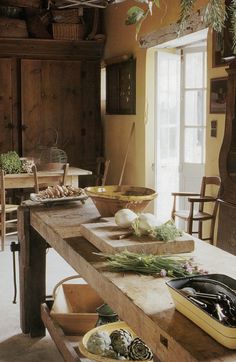 an old fashioned kitchen with lots of food on the table