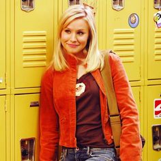 a woman standing in front of yellow lockers