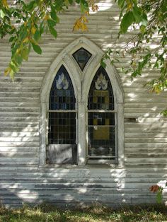 an old white church with stained glass windows