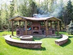 a gazebo sitting in the middle of a lush green field