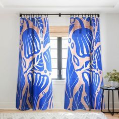 a bedroom with blue curtains and a white rug