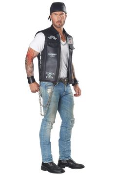 a man in jeans and a leather vest is standing with his hands on his hips