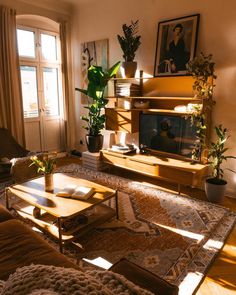 a living room filled with furniture and a flat screen tv sitting on top of a wooden table