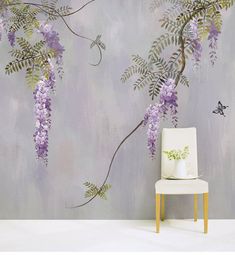 a chair sitting in front of a wall with purple flowers on it and a butterfly flying by