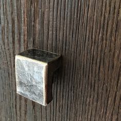 an old metal door handle on a wooden door