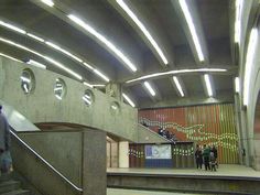 an escalator in a subway station with people walking up and down the stairs