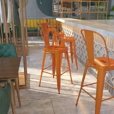 four orange chairs sitting next to each other on top of a tiled floored area