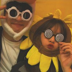 a man and woman are dressed up as pokemons with their eyes covered by fake ears