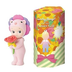 a pink toy holding a flower in front of a box