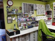 a room filled with lots of crafting supplies and storage space next to a wall mounted clock