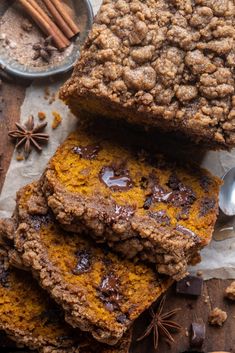 slices of pumpkin spiced bread on top of parchment paper next to cinnamon sticks and anisette