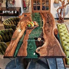 the table is made out of wood and has green velvet chairs around it, along with a bowl of fruit