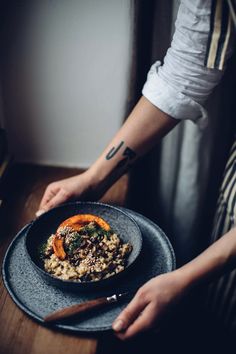 a person holding a plate with food on it