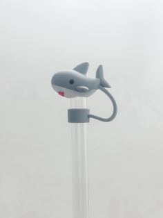 a toothbrush holder with a shark on it's head and mouth sticking out