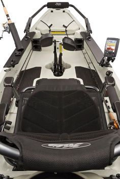 the front end of a boat with two fishing rods and an electronic device in it