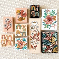 several different types of cards with flowers and birds on them, sitting on a white surface