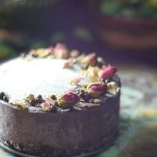 a close up of a cake on a table with other food items in the background