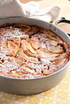 a cake sitting on top of a pan covered in powdered sugar