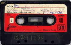 an old red and black cassette with writing on it