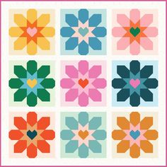 a quilt pattern with hearts and flowers on the front, in different colors for each block