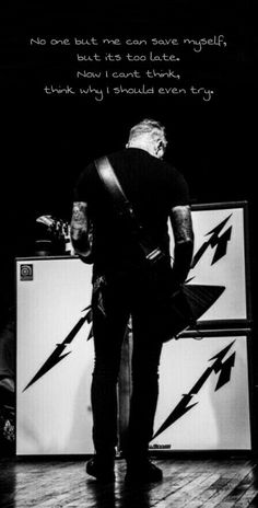 a man standing on top of a wooden floor next to a refrigerator