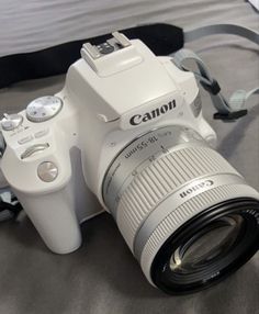 a white camera sitting on top of a table