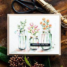 a card with three mason jars filled with flowers and the words grateful for you on it