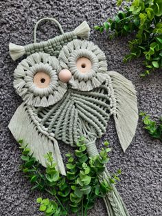 an owl decoration made out of yarn on the ground