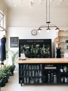 the interior of a flower shop with lots of plants