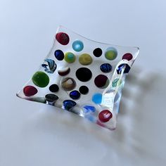 a glass plate with different colored dots on it