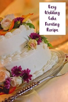 a wedding cake sitting on top of a silver platter next to a sign that says easy wedding cake frosting recipe