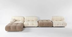 a white and brown couch sitting next to each other on a white floor with no one in it