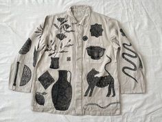 a white jacket with black drawings on it