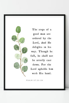 a framed print with the bible verse on it and a green plant in front of it