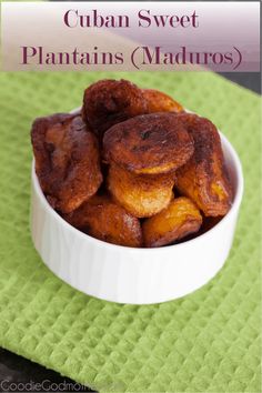 a white bowl filled with fried plantains on top of a green towel