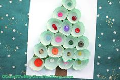 a paper plate christmas tree with buttons on it