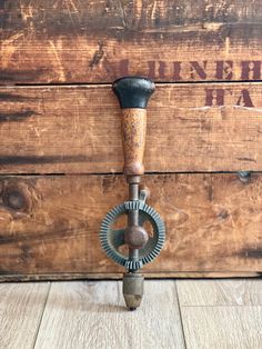 an old fashioned metal hook on a wooden wall with the word mine hill ha written above it