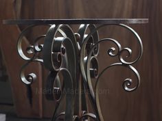 a metal table with an intricate design on it