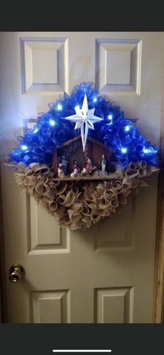 a nativity scene is displayed on the front door with blue lights and burlocks