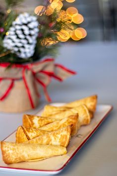 some food is sitting on a plate near a christmas tree