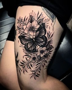 a woman's thigh with a butterfly and flowers on it