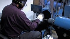 a man working on a machine in a factory