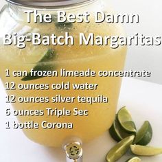 the best damn big - batch margaritas recipe is in a mason jar with lime slices