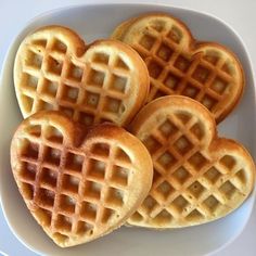 three heart shaped waffles on a white plate