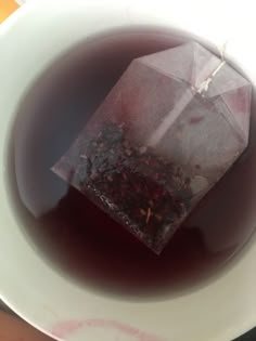 a white bowl filled with liquid and tea